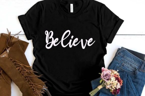 Black t-shirt with 'Believe' in white script, paired with jeans, brown boots, and a small bouquet.