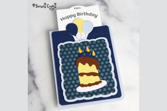 Blue fun fold card with a cake design and pull tab showing 'Happy Birthday' and balloons, perfect for Cricut crafting.