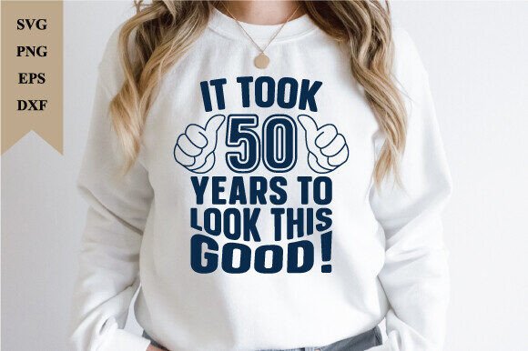White sweatshirt with 'It Took 50 Years to Look This Good!' in bold blue text and thumbs-up graphics.