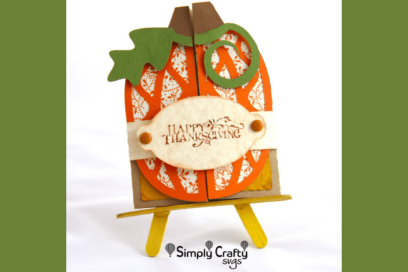 Pumpkin-shaped double fold card with 'Happy Thanksgiving' text, displayed on a small easel.