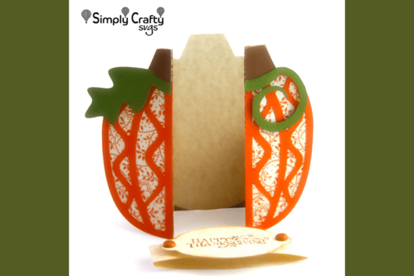 Open pumpkin-shaped card showing inner panel, with detached 'Happy Thanksgiving' label in front.