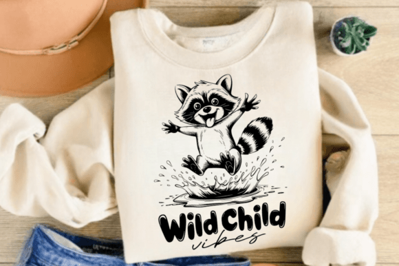 Beige sweater featuring a raccoon jumping with 'Wild Child vibes' text, ideal for Cricut enthusiasts.