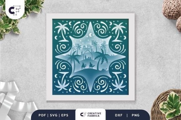 3D shadow box with nativity scene, palm trees, and starry sky in a white frame.