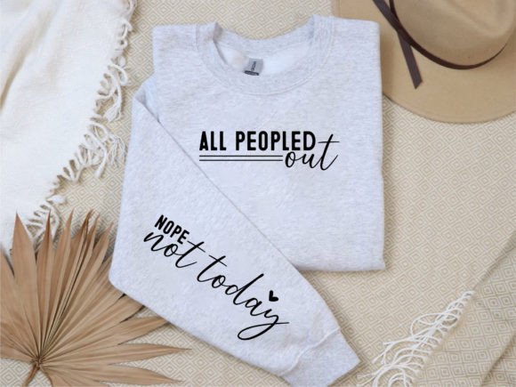 Gray sweatshirt on a beige surface with 'All Peopled out' text on the chest and 'Nope not today' on the sleeve, ideal for Cricut projects.