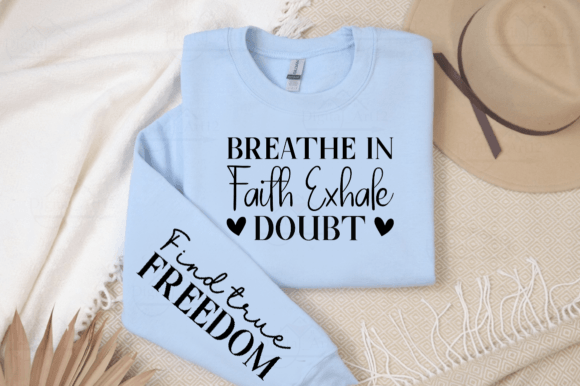 Light blue sweatshirt with 'Breathe in Faith Exhale Doubt' on chest and 'Find true Freedom' on sleeve.