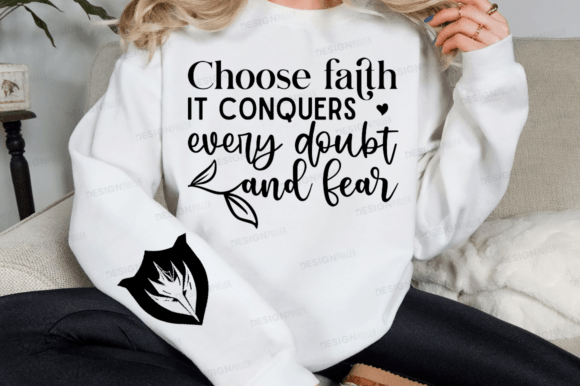 White sweatshirt featuring 'Choose faith it conquers every doubt and fear' text with a leaf design on the sleeve.