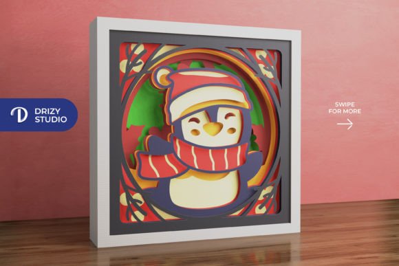 Festive penguin in a 3D shadow box wearing a Santa hat and scarf, perfect for Cricut crafts