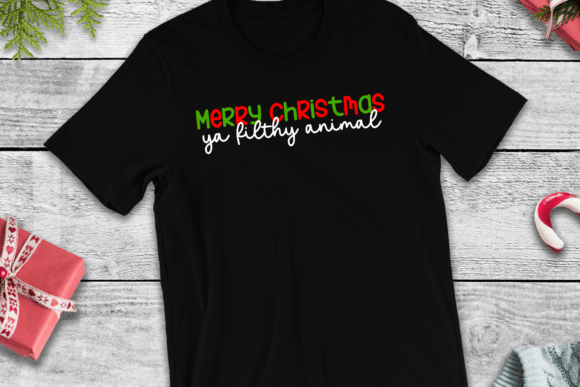 Black t-shirt featuring 'Merry Christmas Ya Filthy Animal' SVG design in festive colors, suitable for Cricut use.