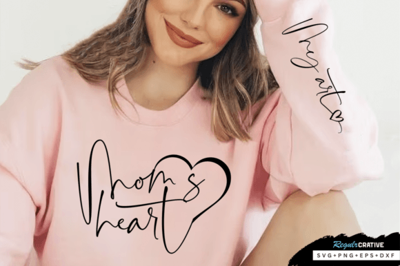 Woman in pink sweatshirt with 'Mom's heart' and 'My heart' text design.