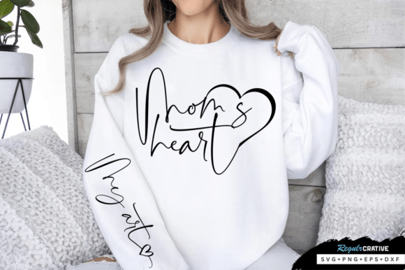 Woman in white sweatshirt featuring 'Mom's heart' and 'My heart' text design.