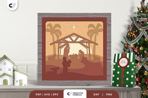 Nativity scene shadow box with palm trees and a stable, featuring figures of Mary, Joseph, and baby Jesus.